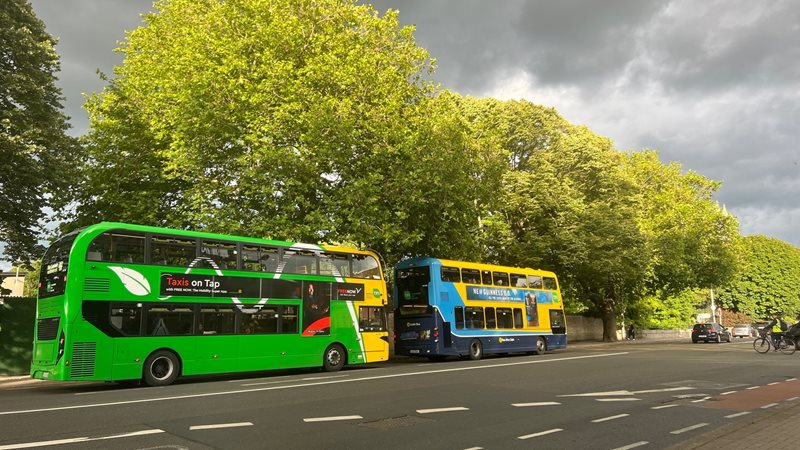 Image of two Dublin Buses driving past each other on the road