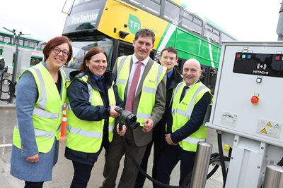 Anne Graham, Female Driver, Eamon Ryan, Male Driver and Billy hann pose in depot in front of electric bus